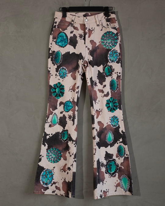 Flared jeans cowprint con turquesas